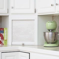 a green mixer sitting on top of a counter next to a box of candy bars