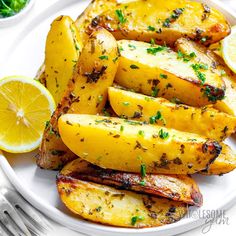 grilled pineapple and lemon wedges on a white plate