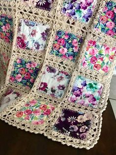 a crocheted blanket with flowers on it