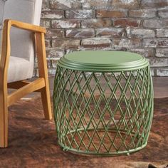 a green table sitting next to a wooden chair on top of a carpeted floor