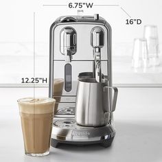 an espresso machine next to a cup of coffee with measurements on the side