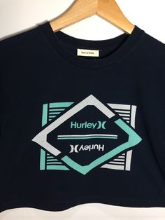 XS Hurley cropped graphic tee in navy blue. Navy Graphic Print Tops For Streetwear, Navy Graphic Tee With Screen Print, Navy Graphic Print Crew Neck Top, Cropped Graphic Tees, Urban Threads, Crop Tee, Savannah Chat, Graphic Tee, Graphic Tees