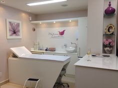 a salon room with white counter tops and chairs