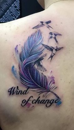 a woman's back with a tattoo that says wind and change on the side