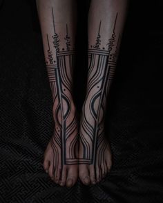 a woman's legs with tattoos on them