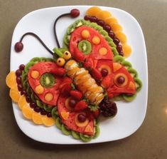 a white plate topped with fruit and veggies