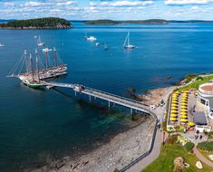 an aerial view of a pier with boats in the water