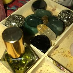 several different colored rocks in a wooden box