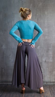 These comfortable flared leg flowy pants are super flattering and fun to wear because of the gracefully flared leg. The fold-over waistband flattens the tummy, giving a smooth look. Perfect for dressing up or casual wear; at the office, at the beach, yoga, dancing, even a night on the town! Made from a deliciously soft fabric with wonderful stretch-and holds it shape well. This fabric is a very high quality rayon lycra blend. Shown here in Mocha, paired with the Aine Ballet Jacket in Ocean. The Paris Flared Leg Pants are also available in Black & Burgundy. Great attention to detail when creating each item guarantees long lasting wear. When properly cared for, these clothes remain beautiful year after year. Care Instructions: Hand wash cold & hang to dry. Ballet Jacket, Wide Leg Yoga Pants Outfit, Wide Leg Yoga Pants, Yoga Dress, Gaucho Pants, Wrap Pants, Womens Trousers, Beach Yoga, Backless Jumpsuit