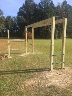 a wooden structure in the middle of a field