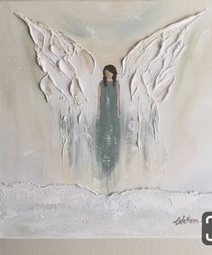 an angel painting with white wings on a wall