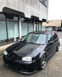 a black car parked in front of a building