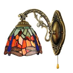 a wall light with a stained glass shade on the back of it's arm