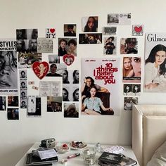 a white table topped with lots of pictures and posters