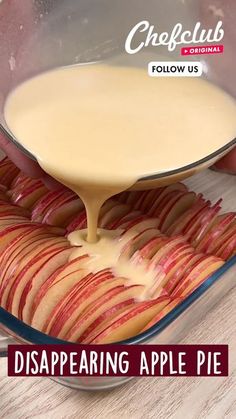 apple pie being drizzled with caramel sauce in a glass baking dish