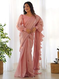 Introducing our stunning "fascinating peach organza designer readymade saree with blouse" that is sure to make you stand out at any party or reception. Made from high-quality peach color organza material, this saree features intricate ruffle details and a fancy lace border for a touch of elegance. The saree comes with a fully stitched blouse material in matching color and is available in sizes XS to XXL, making it the perfect fit for everyone.
This saree include its trendy lace work, which adds Lehenga Crop Top, Lehenga Choli Wedding, Party Wear Lehenga Choli, Reception Gown, Bollywood Lehenga, Ruffle Saree, Readymade Saree, Ready To Wear Saree, Organza Sarees