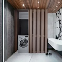 a washer and dryer in a bathroom with wood slats on the wall