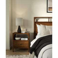 a bedroom scene with focus on the bed and nightstand