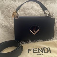 This Authentic Fendi Bag In Almost Excellent Condition,Features A Reversed F Logo Clasp On The Front Flap, A Top Handle With Silver & Golden Hardware. It Comes With Extra Long Strap, Dust Bag & Authenticity Cards.The Front Flap Opens To A Velvet F Logos & Black Interior With A Patch Pocket.This Ultra Chic Bag Is Perfect For A Day Or Night Outs. Measures 10 X 7 X 15 X 35 Fendi Kan I, I Logo, F Logo, Fendi Bag, Chic Bags, Fendi Bags, Black Interior, Extra Long, Patch Pocket