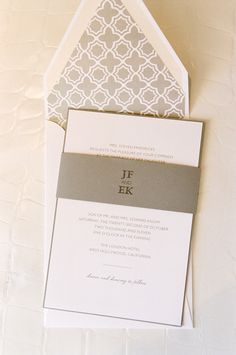 the wedding stationery is laid out on top of each other, including an envelope