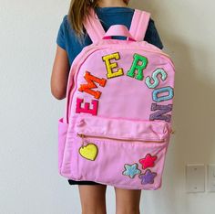 Super cute lightweight nylon backpacks! These can be worn as is or personalized with patches of your choice! These make great travel bags or back to school backpacks! Can get matching zipper bag or pencil case in other listings! Dimensions: 15 by 11 by 5 in Select number of patches and in the personalization section please be specific about what you want and placement! This bag can fit 5-6 letters across and can have other fun patches spread around the bag ARCHING NAME IS DONE AT OUR DISCRETION Pink School Bag With Letter Patch, Pink School Bags With Letter Patch, School Bag With Letter Patch For Back To School, School Bags With Letter Patch For Back To School, Back To School Bags With Letter Patch, School Backpack With Embroidered Patch, Personalized Pink Everyday Backpack, Fun Patches, Back To School Backpacks