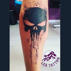 a person with a black and white tattoo on their leg that has a skull painted on it