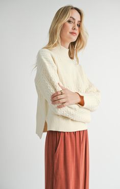 Stay warm and stylish in our Liss Turtleneck Sweater. This pullover features a thick, luxurious knit and a flattering mock neck design. The relaxed, slightly cropped fit is perfect for pairing with high-waisted pants. With cozy cable knit detailing and a slight high-low hem, this sweater offers both comfort and a chic look! Your fall wardrobe is calling! Relaxed boxy fit, oversized in all the right ways while still looking chic! True to size Mock Neck to help you stay cozy and stylish without be Stay Cozy, Fall Wardrobe, High Low Hem, High Waisted Pants, Neck Designs, Turtleneck Sweater, Bottoms Pants, Stay Warm, Sweater Hoodie