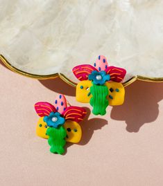 Introducing our Waling Waling Mini Earrings - a tribute to the majestic "Queen of Philippine flowers"! 🌸 Embrace the spirit of the Bagobo diwata and let your aspirations reach new heights, just like this orchid's journey to the sun. 🌞 Unfazed by its surroundings, it flourishes with a symbol of Filipino independence, yet thrives in harmonious partnerships with the ditherocarps. 🌿 Endemic to the lush landscapes of Davao, Sultan Kudarat, and Mindanao's heart, these earrings encapsulate the essen Whimsical Earrings For Festivals, Whimsical Multicolor Festival Earrings, Festival Gift Flower Earrings For Pierced Ears, Festival Flower Earrings For Pierced Ears, Unique Multicolor Earrings For Celebration, Unique Multicolor Flower Earrings Gift, Artistic Multicolor Flower Earrings, Unique Flower-shaped Earrings For Festival, Unique Flower Shaped Earrings For Festivals