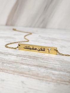 Wear on one of AYAT's accessories and be encouraged, blessed, and affirmed with words of Scripture and wisdom. A creative way to celebrate your belief in style while making a declaration of faith! Find the jewelry that speaks to your heart and testimony by exploring our collection today. Front Side: لتكن مشيئتك Back Side: 10:6 متى  Material: Stainless Steel Gold Plated Tag Dimensions: 4 x 0.6 cm Chain Length: 46 cm (including 10 cm adjustable) Inspirational Adjustable Necklace As Gift, Inspirational Adjustable Necklace For Gift, Inspirational Engraved Adjustable Necklace, Spiritual Jewelry For Mother's Day, Inspirational Rectangular Jewelry For Gifts, Personalized Brass Bracelets As Gift, Personalized Brass Bracelets For Gift, Engraved Cross Jewelry For Blessing, Spiritual Nameplate Jewelry For Gifts