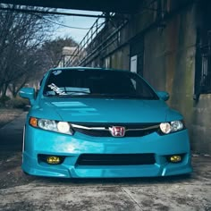 a blue car parked in front of a building