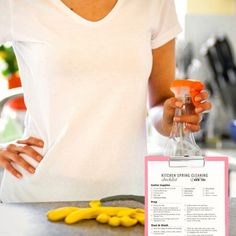 a woman standing in front of a kitchen counter holding an orange and yellow bottle with the label on it