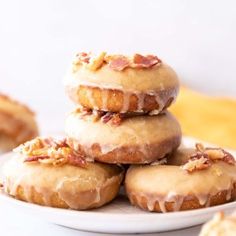 a white plate topped with donuts covered in icing