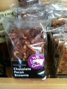 chocolate pecan brownie bars wrapped in plastic wrappers on a shelf with other packaged food items