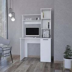 a white computer desk sitting on top of a hard wood floor next to a chair