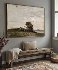 a painting hanging on the wall next to a bench in a room with a rug