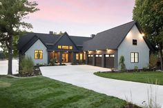 a large white house sitting on top of a lush green field