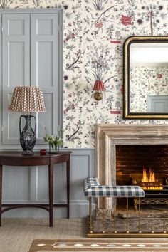 a living room filled with furniture and a fire place in front of a wall mounted mirror