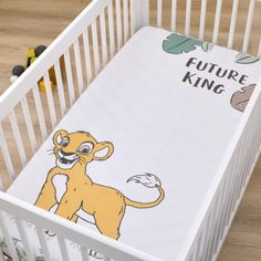 a white crib with a cartoon lion on it's side and the words future king written in black