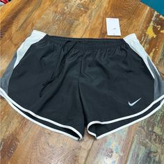 Black Nike Shorts With White And Grey Trim. Elastic Drawstring Waist With Built In Briefs. Small Waistband Pocket. Dri Fit Fabric To Keep You Dry And Comfortable. Casual Gray Running Shorts, Gray Casual Running Shorts, Nike Gray Running Bottoms, Nike Gray Workout Shorts, Nike Bottoms With Built-in Shorts In Gray, Nike Athletic Shorts With Moisture-wicking, Nike Activewear With 4-way Stretch And Built-in Shorts, Nike Cotton Activewear With Built-in Shorts, Nike Moisture-wicking Athletic Shorts For Basketball