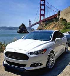 two white cars parked in front of the golden gate bridge, san francisco, california