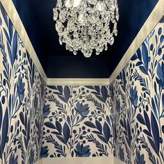 a chandelier hanging from the ceiling in a blue and white room