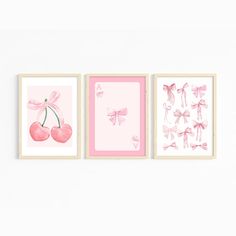 three pink wall art pieces with bows and cherries on the bottom, one is framed in