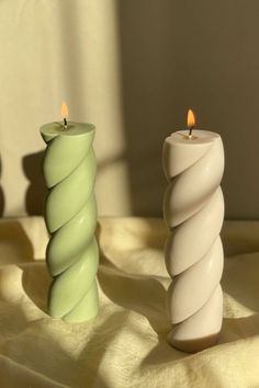 two candles sitting next to each other on a table