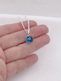 "925 Sterling Silver Evil Eye Necklace. It helps ward off all evil eyes from you and creates a protective shield against you.  The Evil Eye necklace is favorite among celebrities. It's specifically a favorite of Vanessa Hudgens, Cameron Diaz, Sharon Stone, Richard Gere.  . Looking to add customized Charms ? http://etsy.me/ZQ2KkF . More Meaningful Jewelry:  http://www.TitinaJewelry.etsy.com  DETAILS: . Solid 925 Sterling silver cubic zirconia evil eye pendant . . Solid 925 Sterling Silver chain, Authenticity verified, Nickel and lead free.  ~ GENUINE 925 STERLING SILVER JEWELRY 0r FAKE SILVER? -The easiest test to do is to use a magnet. Metals, such as sterling silver, gold and platinum, are non-ferrous materials. If it is attracted to it, then it is not sterling silver. ( except for the cl Sterling Silver Evil Eye Jewelry, Silver Sterling Evil Eye Jewelry, Silver Sterling Silver Evil Eye Jewelry, Evil Eye Silver Jewelry In Sterling Silver, Spiritual Sterling Silver Evil Eye Necklace, Silver Sterling Silver Evil Eye Necklace, Spiritual Sterling Silver Eye-shaped Jewelry, Spiritual Eye-shaped Sterling Silver Jewelry, Sterling Silver Evil Eye Charm Necklace