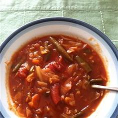 a white bowl filled with stew and vegetables