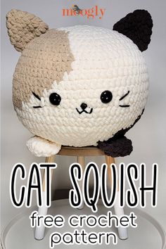 a crocheted stuffed animal sitting on top of a wooden stool with the caption cat squish free crochet pattern