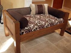 a brown and white couch sitting on top of a wooden frame