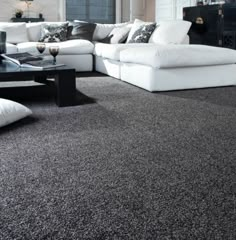 a black and white living room with couches, coffee table and rug on the floor