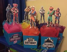 several toy figurines sitting on top of birthday boxes