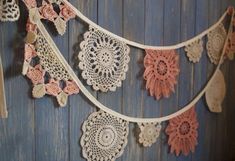 crocheted doily hanging on the side of a wooden wall